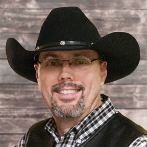man smiling with a black cowboy hat
